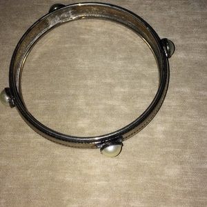 Silver bangle bracelet with faux pearl accents.